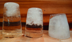 These 3 pieces of ice are sitting top down. All used filtered water. Left: there was a small amount of unfrozen water in the bottom. Fractures and bubbles had started to form. There is plenty of usable clear ice in this piece. Center: the ice has frozen to the bottom. Fractures take up half of the ice. Right: this piece froze from all directions and is heavily fractured.