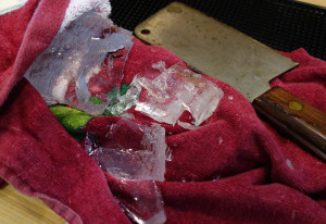 To remove the partially frozen bottom, hold the ice with a towel and tap it with a heavy knife.
