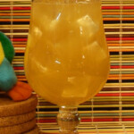 Yellow iced drink in stemmed glass