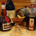 Manhattan 3.0 with Sherry Cask Aged Bourbon A bottle of bourbon, a cocktail glass, and a bottle of rum.
